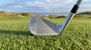 Narrow sole of a players iron designed for precise turf interaction on tight UK fairways.