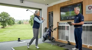 A senior lady golfer undergoing a professional club fitting session at a UK golf academy using Trackman launch monitor technology.
