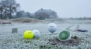 High-visibility yellow golf balls that reduce slice, positioned on a frosty British tee box.