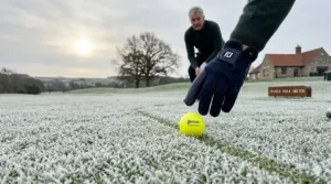 Alt text for image 4: A yellow golf ball positioned on a white, frosted fairway providing high contrast for easy retrieval.
