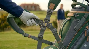 Demonstration of the quick-release clips on a modern golf carry bag strap.