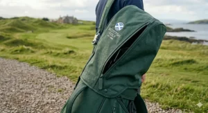 Golf carry bag with a protective rain hood attached for wet weather play.