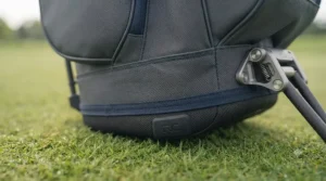 A golfer walking across a links course comfortably carrying a lightweight stand bag.
