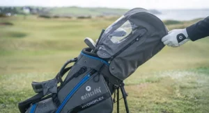 Motocaddy HydroFlex golf bag fitted with its matching waterproof rain hood for wet days on the course.