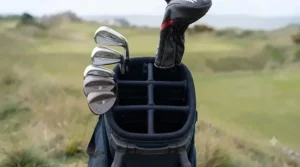 Overhead view of the four-way top cuff and full-length dividers on the Titleist Players 4 stand bag, with golf clubs neatly organised.