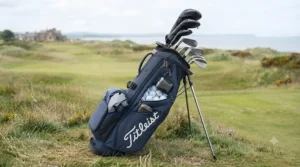 The navy Titleist Players 4 stand bag fully loaded with a full set of Titleist clubs, numerous golf balls in the ball pocket, and accessories, ready for play.