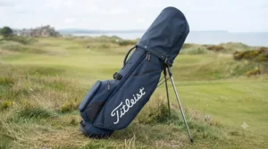 Full side profile of the navy Titleist Players 4 stand bag, clearly displaying the large, white embroidered 'Titleist' script logo.