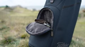 Close-up of the soft, velour-lined valuables pocket on the navy Titleist Players 4 stand bag, designed to protect delicate items like phones and watches.
