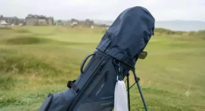Close-up of a waterproof golf bag featuring a securely fastened rain hood to protect clubs.