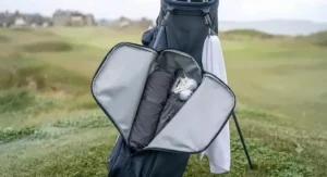 A side pocket of a waterproof golf bag showing storage for golf balls and accessories.