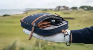 Open golf valuables pouch showing a soft velvet-lined interior and separate compartments for mobile phones and car keys.
