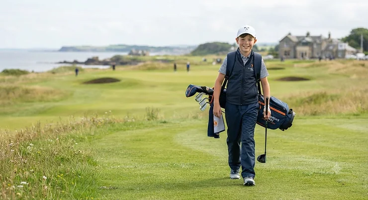 Lightweight junior golf bag resting on the fairway of a British golf course, suitable for kids and teenagers. junior golf bag