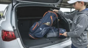 Ultra-lightweight junior golf bag being lifted easily by a young player before a coaching session.