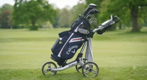 A golfer carrying a comfortable dual-strap lightweight golf bag across the rough.