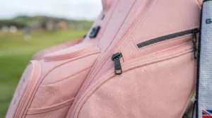 Close-up of durable, waterproof pink fabric on a golf bag designed for unpredictable British weather.