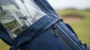 Close-up of taped waterproof seams and easy-access zips on a golf bag rain cover.