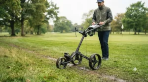Durable ball-bearing wheels on a cheap push trolley rolling smoothly over damp turf.