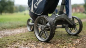 Detailed view of the dual front wheels on a 4-wheel golf push trolley designed for uneven terrain.