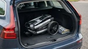 Compact folded frame of an MGI golf trolley sitting in the boot of a car.