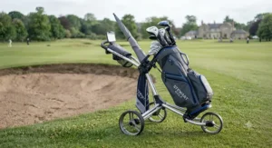 Stewart Golf electric trolley fitted securely with a branded cart bag, scorecard holder, and umbrella mount.