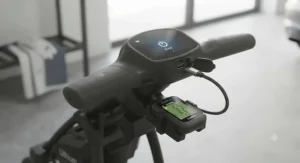 Handle-mounted USB charging port on a golf trolley powering a portable GPS device during play.
