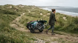 A compact push golf trolley for travel navigating a traditional coastal links golf course in the UK